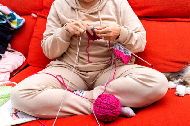 istock Young girl in pajamas knitting on the sofa 1441642693