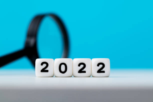 istock New year 2022 and magnifying glass on the table 1441651411