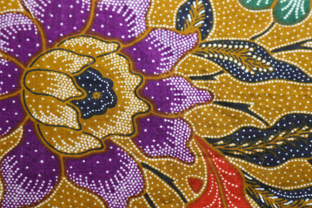 istock Ocher color based Batik fabric with oriental purple and white floral texture. 1441652320