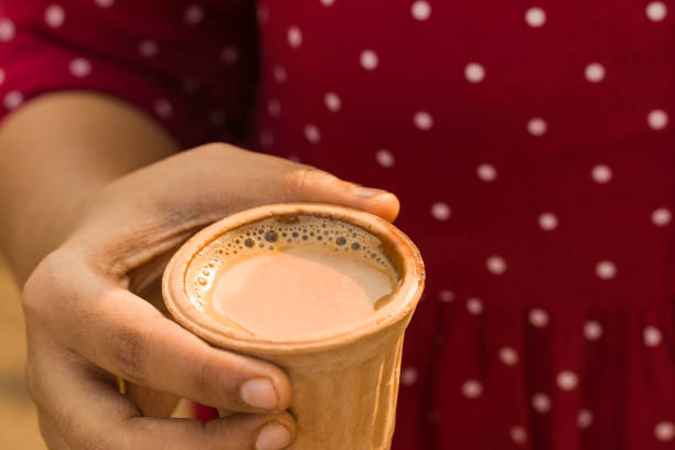 istock a cup of hot tea held in hand. Popular beverage served in earthen clay pot. 1441653759
