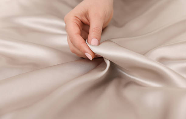 istock Woman touching smooth silky fabric, closeup view 1441656440
