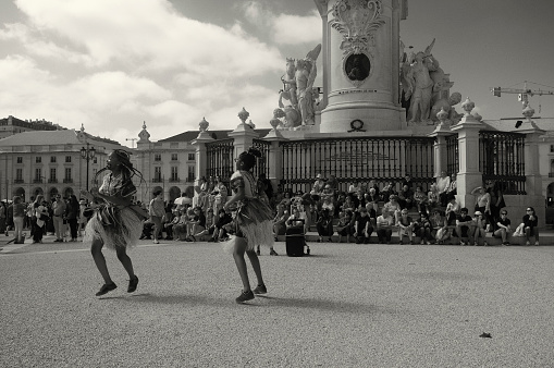 Lisbon, Portugal - May 21, 2022: A group of african dancers perfroms at the Praça do Comércio square in Lisbon downtown.