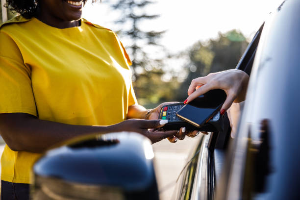 istock Service person getting a payment with smart phone from a customer at the curbside pickup 1441658651