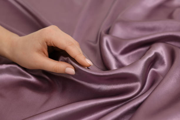 istock Woman touching smooth silky fabric, closeup view 1441658788