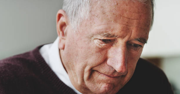 istock Face, depression and lonely with a senior man alone in a retirement home feeling sad or down. Mental health, thinking and depressed with an elderly male pensioner looking worried in his house 1441659101