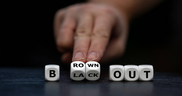 istock Hand turns dice and changes the expression 'blackout' to 'brownout'. 1441659204