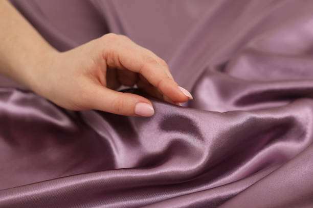 istock Woman touching smooth silky fabric, closeup view 1441659227