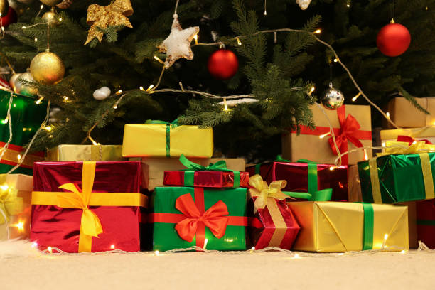 istock Many different gift boxes on floor near Christmas tree 1441659302