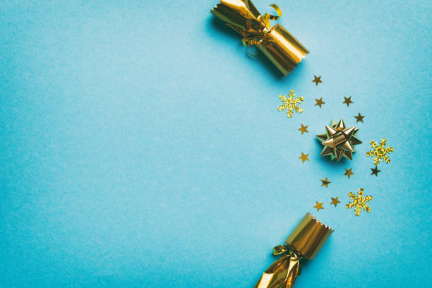istock Christmas crackers with shiny confetti on color background, top view, copy space 1441660335