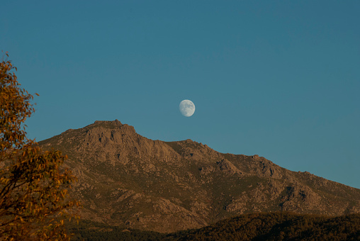 moon rising next to mountain in Extremadura peak Pinajarro