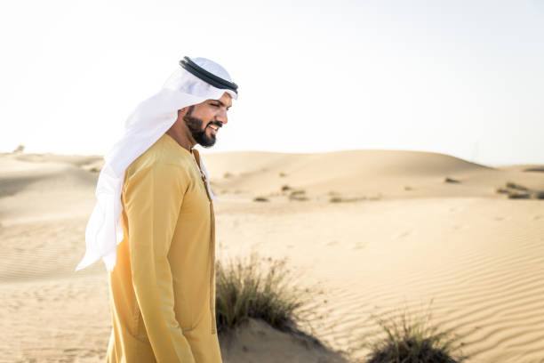istock Arabian man walking in the desert 1441667416