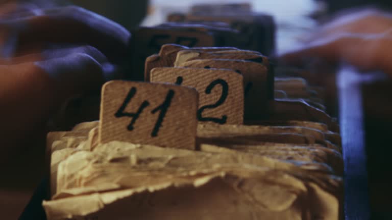 A man searching information in an old card catalogue