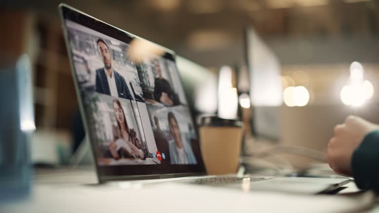 Multiethnic People Conference Meeting Online and Discussing Business Project. Laptop Screen Containing a Group Video Call. Colleagues Working From Home and Collaborating on Internet