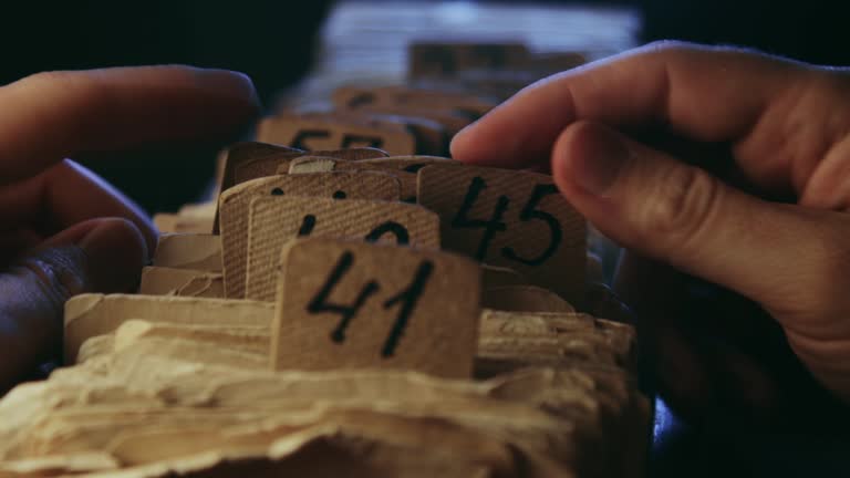 A man searching information in an old card catalogue