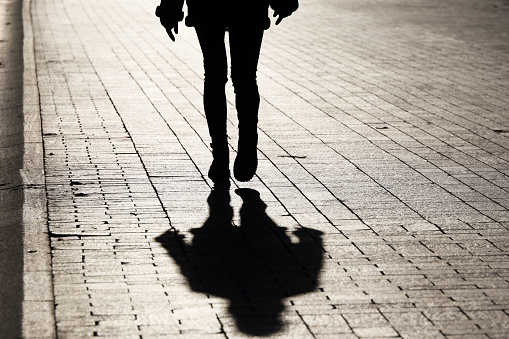 Female legs in tight jeans and boots, dramatic life