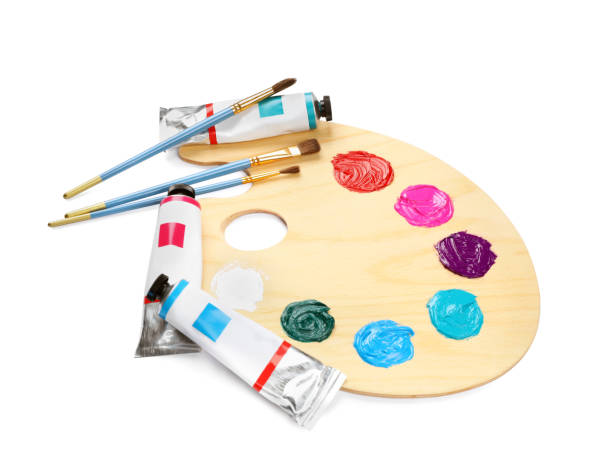 istock Wooden artist's palette with brushes and paints on white background 1441669830