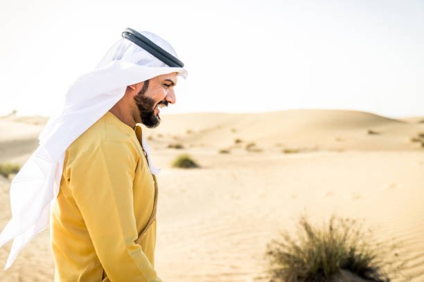 istock Arabian man walking in the desert 1441671336