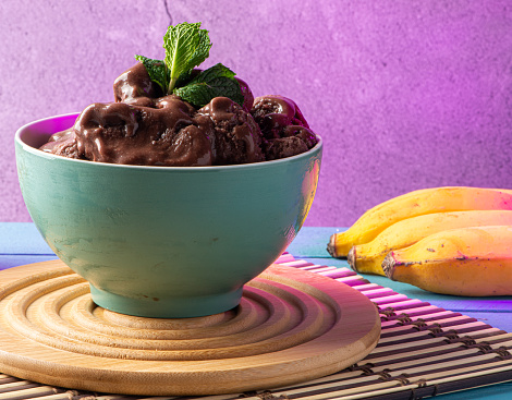 Brazilian frozen acai berry ice cream bowl. with fruits on wooden background.