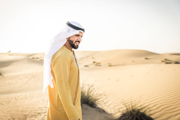 istock Arabian man walking in the desert 1441674770