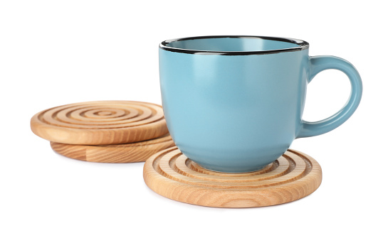 Stylish wooden coasters and cup on white background
