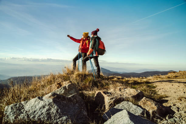 istock Two female hikers enjoying the view from mountain peak on a nice sunny day 1441678346