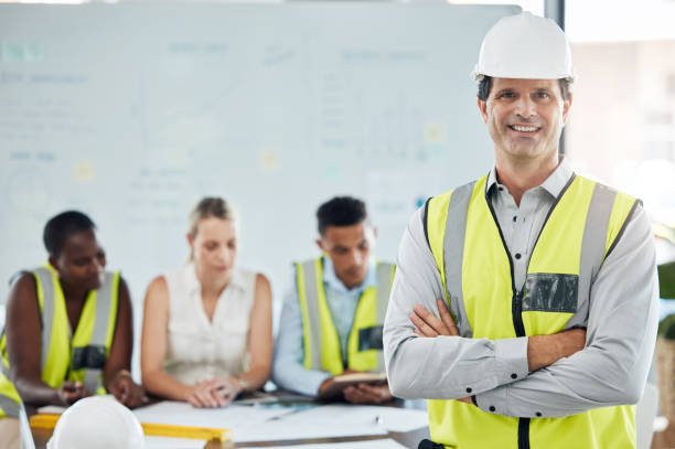 istock Engineer man or architect success leader with team planning strategy for architecture building and engineering vision. Industry development manager or contractor with leadership, diversity and trust 1441678439