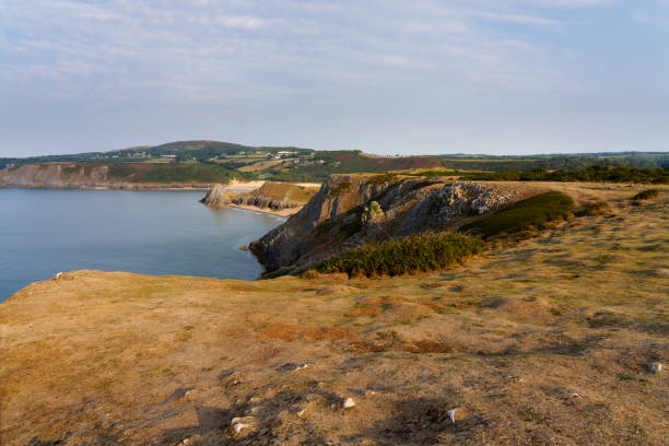 High on the clifftops looking out across Three Cliffs Bay in the early morning sunlight.