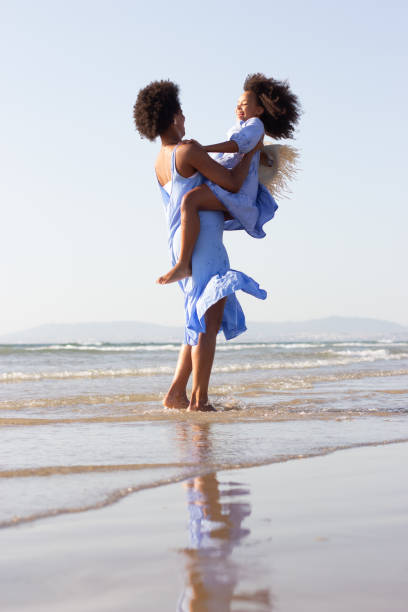 istock Blissful family having fun on beach 1441678878