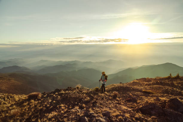 istock Active female hiker walks on a mountain cliff 1441679061