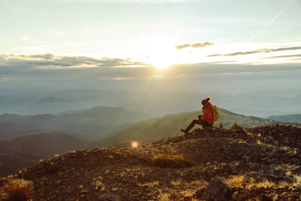 istock Female hiker resting and enjoying the view from a mountain peak 1441679500