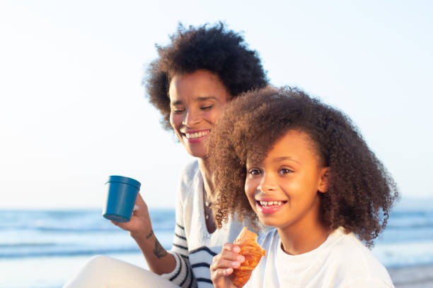istock Tranquil mother and daughter having fun time on beach 1441680091