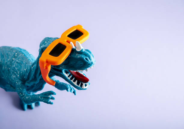 istock Cool blue dinosaur wearing orange sunglasses on violet background. Copy space. Minimal art. 1441682489