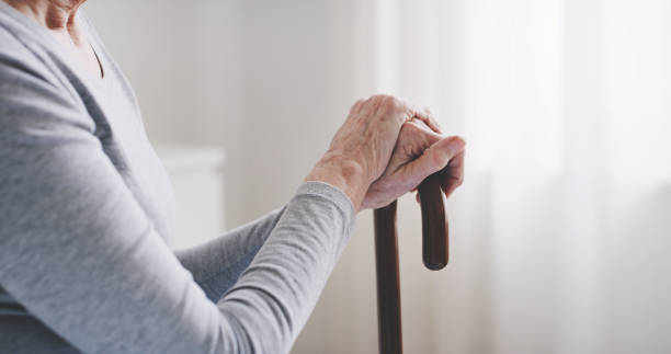 istock Retirement, hands and senior woman with cane for walking support help, assistance or old age movement disability. Healthcare, geriatric elderly care and relax nursing home patient with walking stick 1441683217