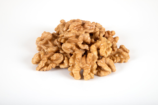 A group of peel walnuts on a white background