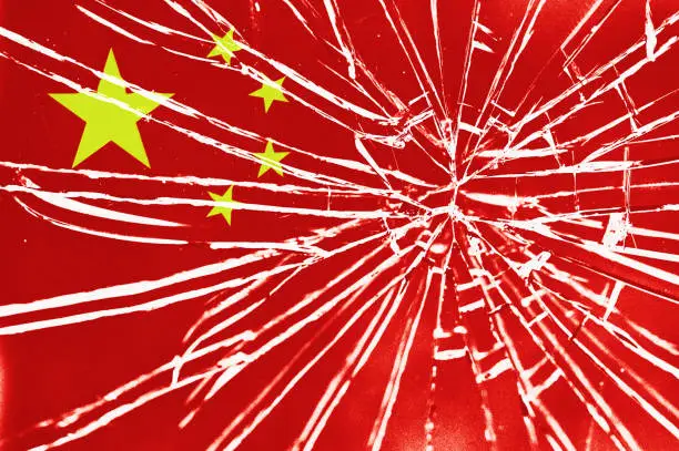 The cracks are showing: national flag of China behind broken glass, with heavy grain and other distressed elements.
