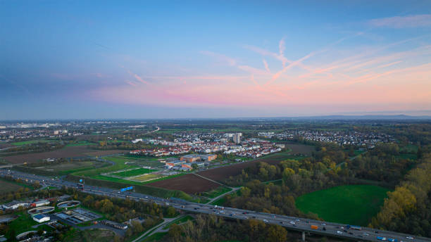 istock Highway and village at dusk - panoramic aerial view 1441684920
