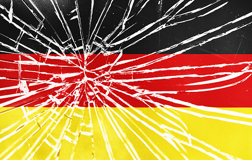Flag of Germany behind shattered glass with radiating cracks
