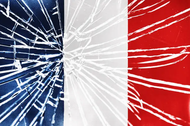 The cracks are showing: national flag of France behind broken glass, with heavy grain and other distressed elements.