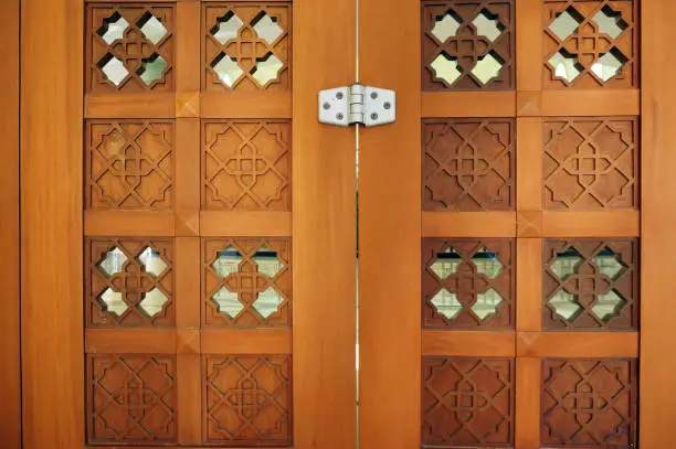 Photo of Islamic carved door in the mosque in Al Faruq Mosque, Sangatta, East Kalimantan, Indonesia.