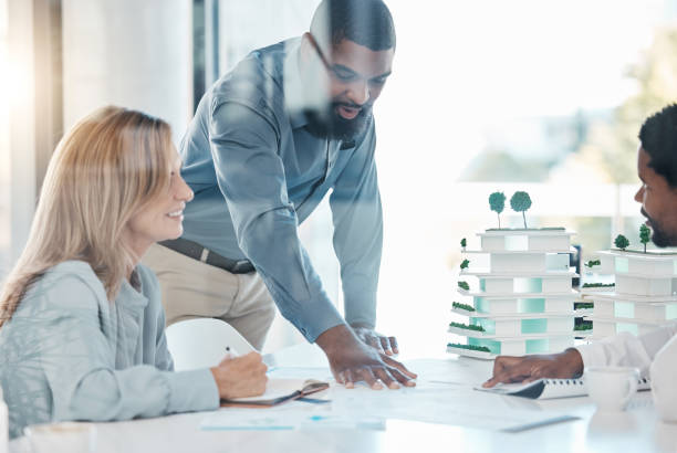 istock Architect, building engineer and meeting with 3d model design in real estate business, construction or property company. Black men or architecture woman in teamwork collaboration with blueprint paper 1441685689