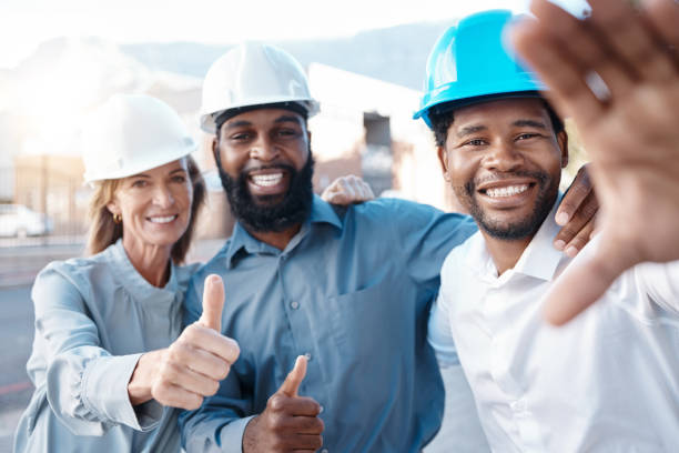 istock Happy, construction site and team selfie with the thumbs up gesture while building, planning and engineering. Architecture, smile and group of architects approve the safety of a development project 1441685710