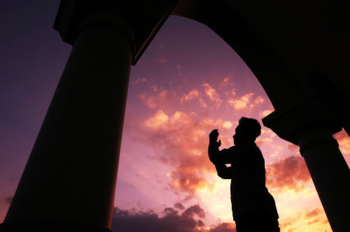 Sangatta, East Borneo, Indonesia. 29 Januari 2020. A man prays outside the mosque on sunset background