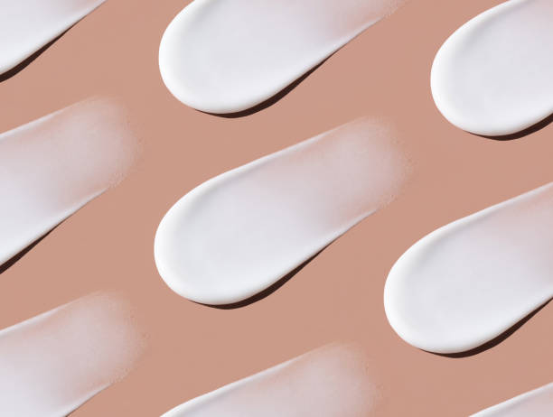 istock pattern  cosmetic smears cream texture on pastel brown background 1441687032