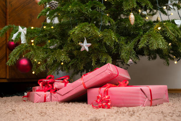 istock Wrapped gifts under the christmas tree. Presents under the decorated pine tree. 1441687744