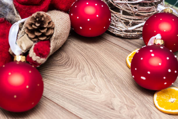 Red ornaments with snowflakes and Christmas decoration on wood table