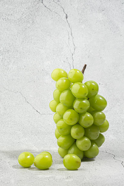 Bunches of Shine-Muscat grapes on a white background. stock photo