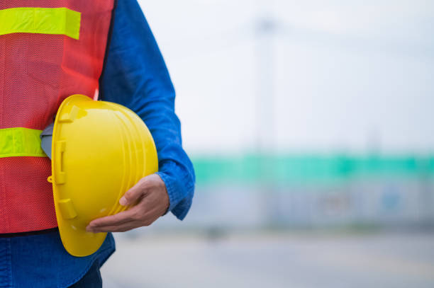 istock Close up hand holding white helmet hard hat Engineering concept, Technician holding hard hat safety hard hat sunlight background 1441691269