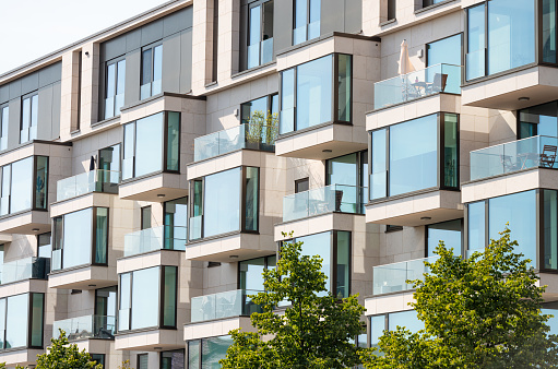 Large windows and balconies on the exterior of a modern luxury apartment building in Berlin.