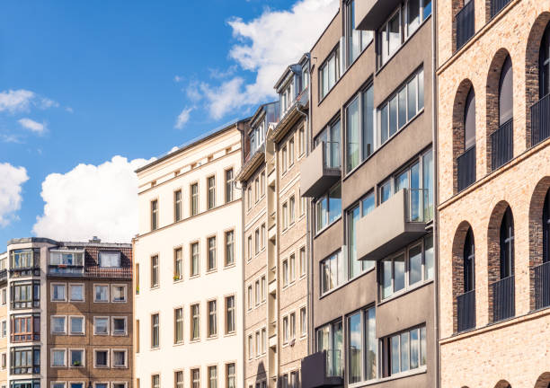 A group of apartment buildings along a street in Berlin, with variations in age and design.