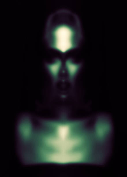 Fine art, sci-fi concept. Abstract and futuristic looking alien or extraterrestrial portrait. Defocused, out of focus and blurred image. Image contain noise and grain. Toned image with green color